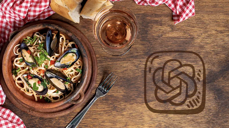 Plato de pasta con mejillones en un tazón de barro sobre una mesa de madera con una servilleta a cuadros rojos y blancos, junto al logotipo de ChatGPT